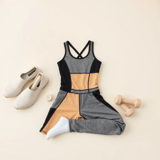 Patchwork fitness suit with color-blocked panels displayed on a neutral studio background