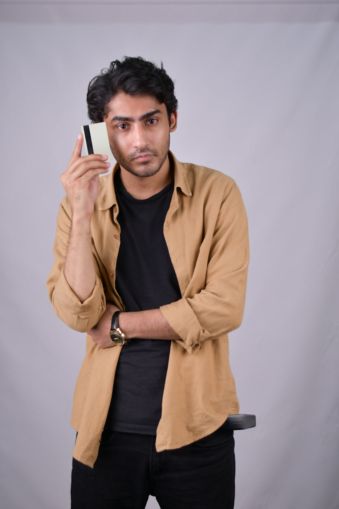 a man holding a cell phone up to his face