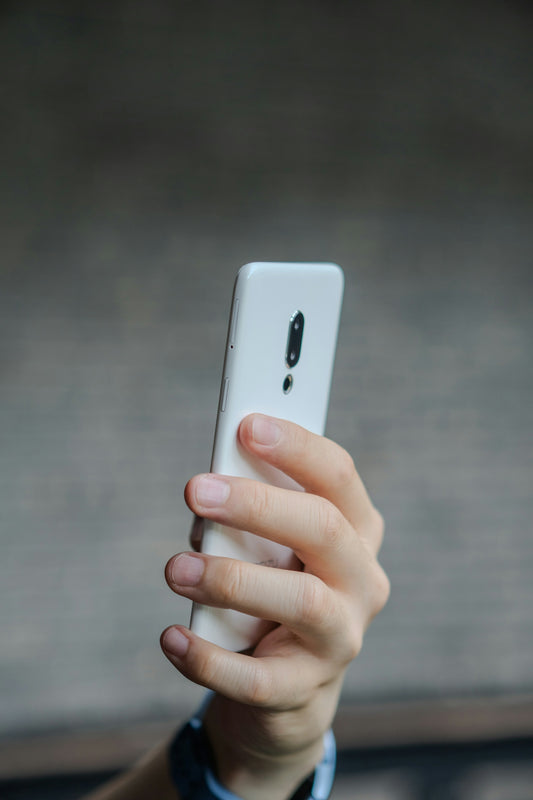 A close up of a person holding a cell phone