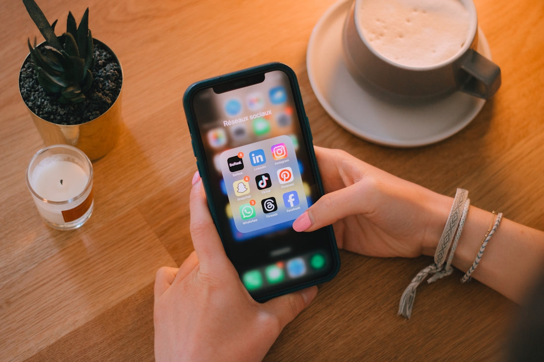 Woman uses a smartphone on a table.
