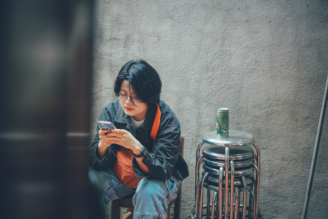 Young woman looking at her phone outdoors