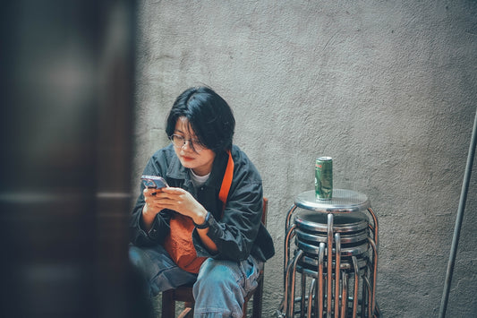 Young woman looking at her phone outdoors