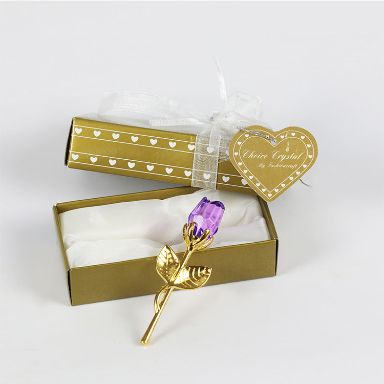 An elegant purple crystal glass rose flower presented in a golden gift box with a heart-shaped tag attached by a ribbon, perfect as a Valentine's Day gift from https://sammyskfootball.com.