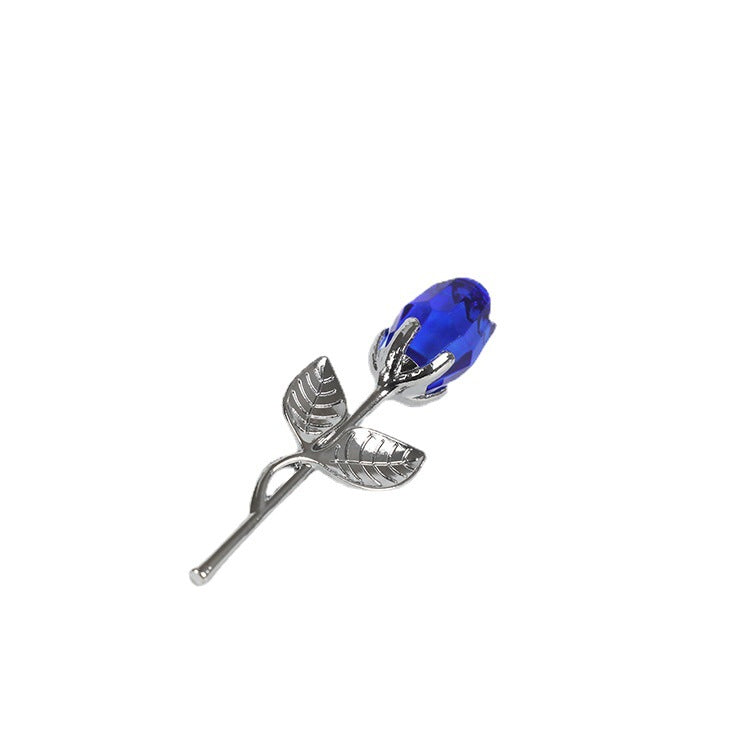 A silver-colored metal rose stem featuring detailed leaves and a striking blue crystal glass bud, making it an ideal Valentine's Day gift. Check out the Valentines Day Gift Crystal Glass Rose Artificial Flower from Sammys K Football.